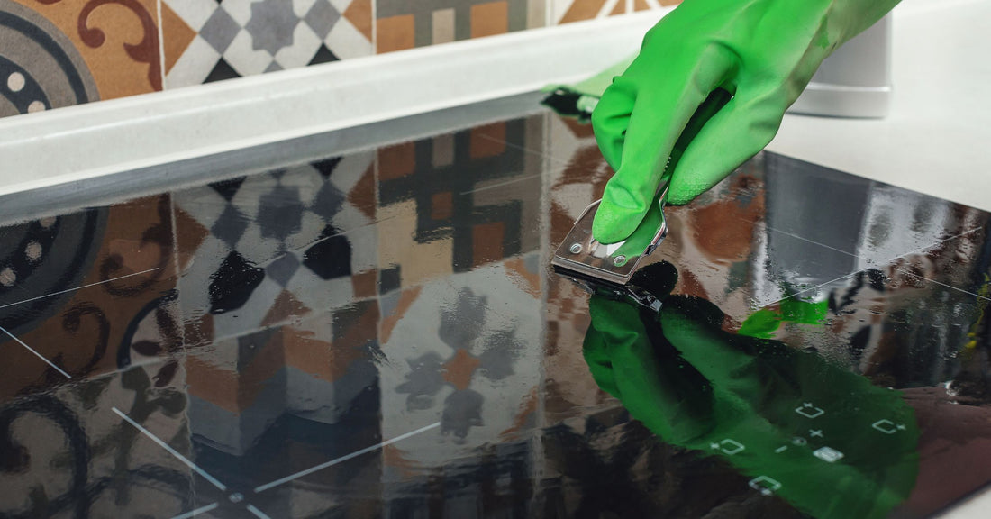 Hob scraper cleaning a ceramic hob